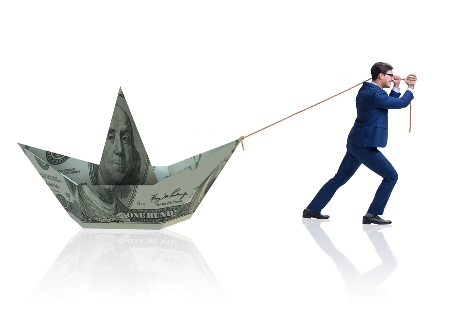 Businessman-pulling-boat-made-from-dollar-banknote