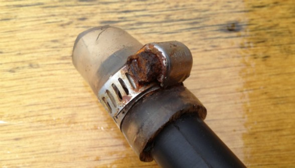 All screw-type hoseclamps eventually need tightening -- if they aren't rusted beyond repair like this one.